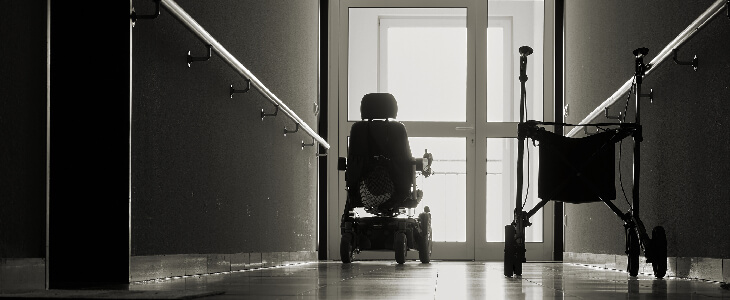 two wheel chairs at a window in a dark hallway nursing home abuse and neglect