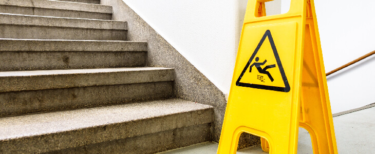 yellow slip trip and fall sign by stairs